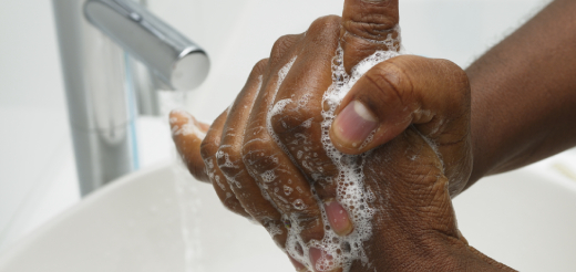 Soapy hands under running water