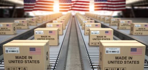 AND ‘Made in United States’ cardboard boxes on conveyor belts with American flags in background