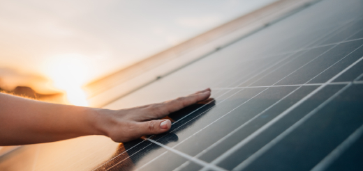 Solar panels against blue sky with white clouds