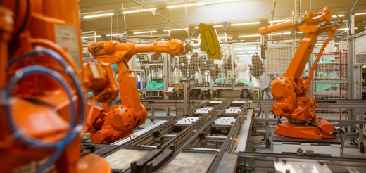 The robotic arms on the assembly line.
