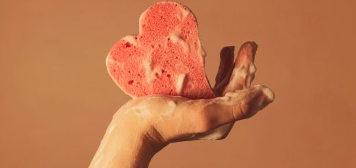 Washing hands with heart-shaped sponge